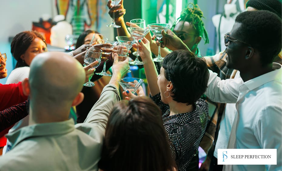 A group of diverse people raise glasses for a celebratory toast in a lively setting