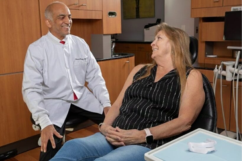 Dr. Pandhi and a patient reviewing a mandibular advancement device on the dental table